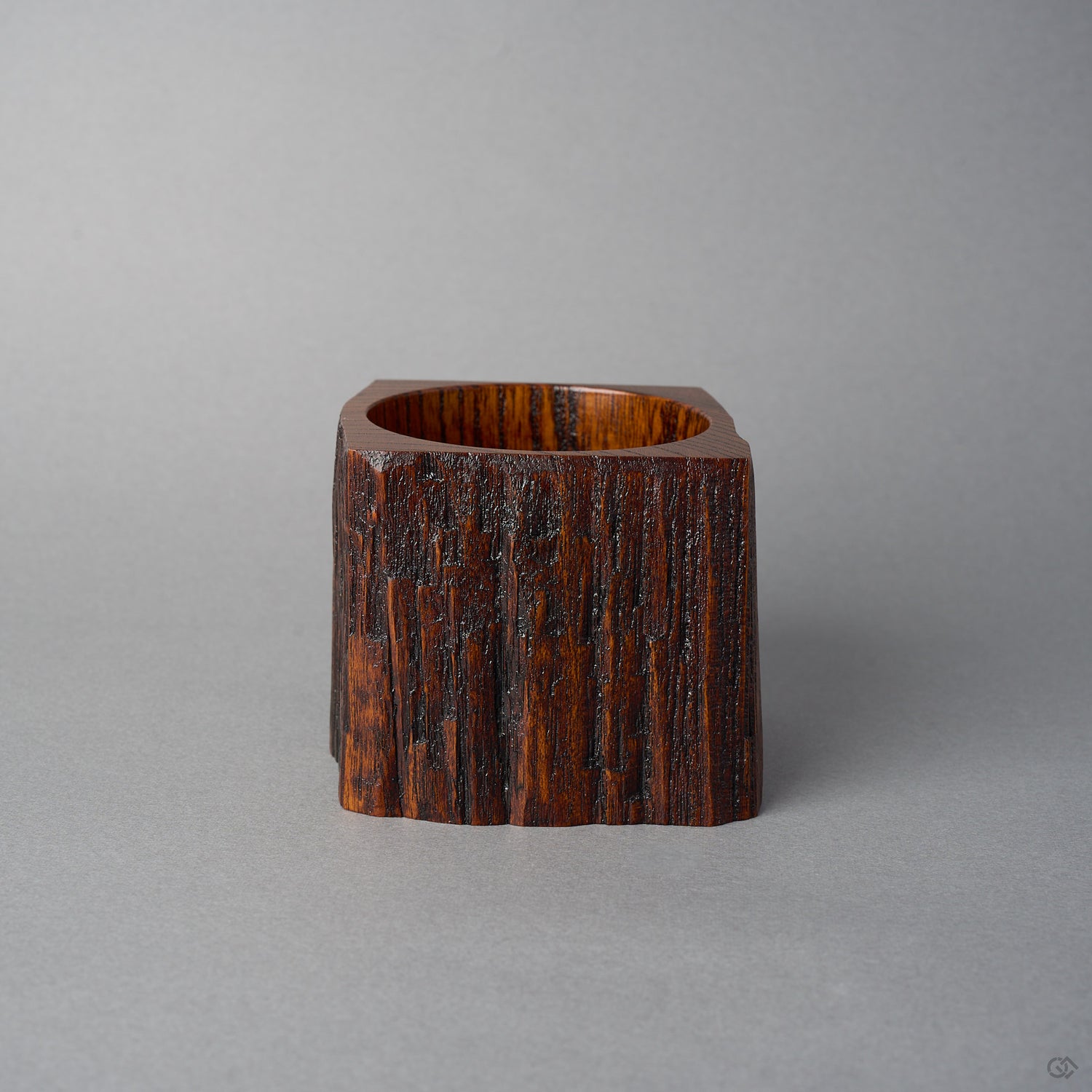 Back view of KODAMA Black Roiro by Nobuyasu Suginaka, showing the rough vertical grain and weathered bark texture of the century-old wood and its carved foot.