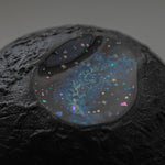 Close view of the carved, cratered gold-leaf surface of Amamitsuki beside its star-filled blue raden window, revealing the layered urushi texture.