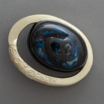 Macro detail of the lacquer dome of Union of Skies, showing raden inlay, tin-powder (suzu-fun) texture, and the gilded ring along the lower edge.
