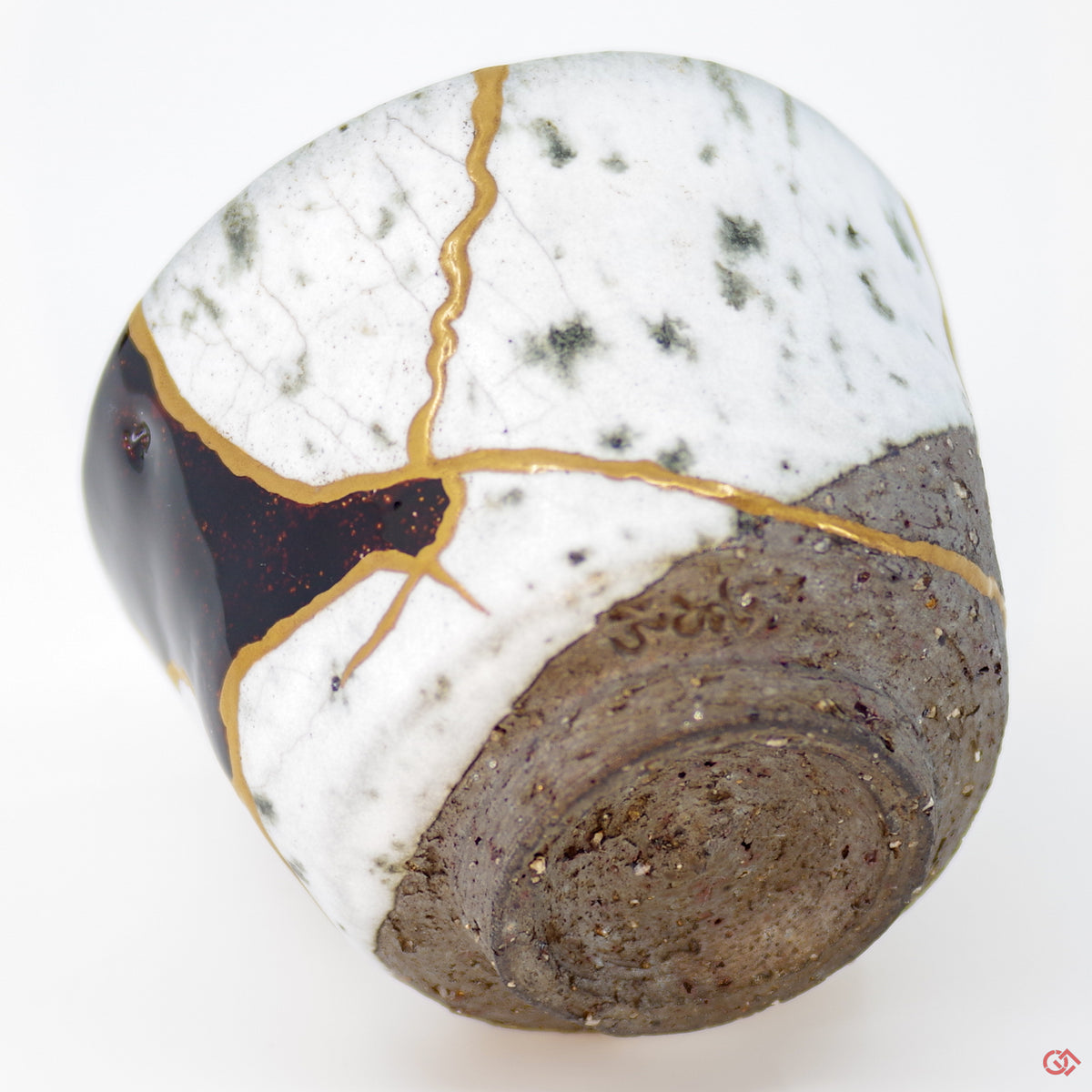 Close-up photo of an authentic Kintsugi pottery piece, showing the detail of its repairs and craftsmanship