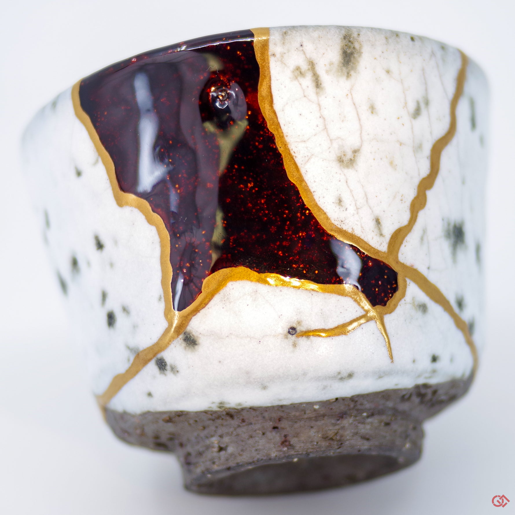 Close-up photo of an authentic Kintsugi pottery piece, showing the detail of its repairs and craftsmanship