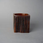 Another side view of KODAMA Nashiji, showing the vertical striped grain and rugged bark texture of the aged wood.