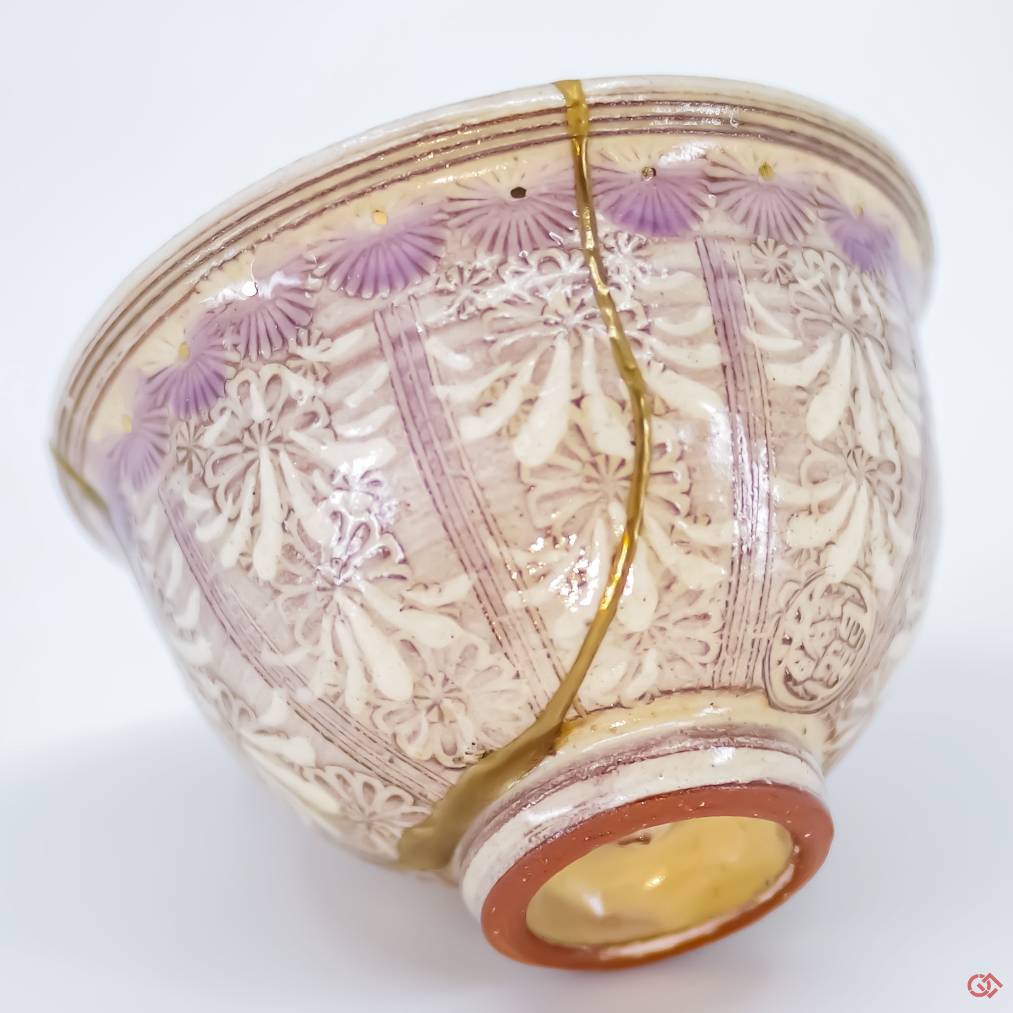 Close-up photo of an authentic Kintsugi pottery piece, showing the detail of its repairs and craftsmanship