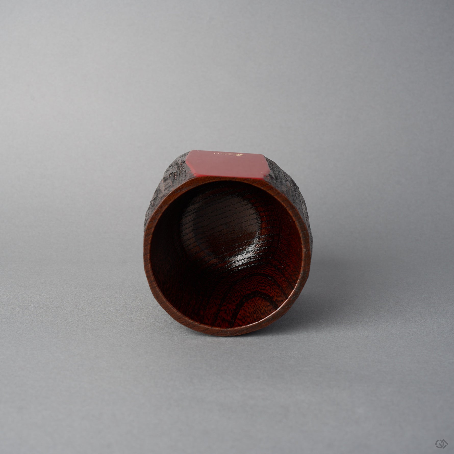 Top view of KODAMA Red Roiro, looking down into the hollowed bowl with its glossy reddish wood-grain interior and the red lacquer rim above.