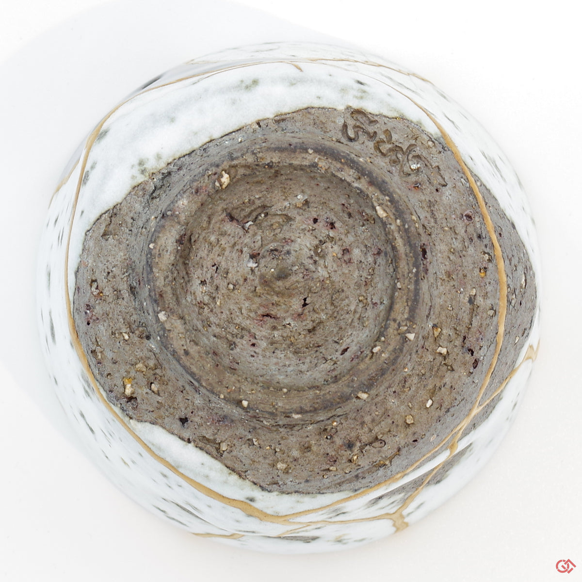 Photo of the bottom side of an authentic Kintsugi pottery piece, showing its overall design and features