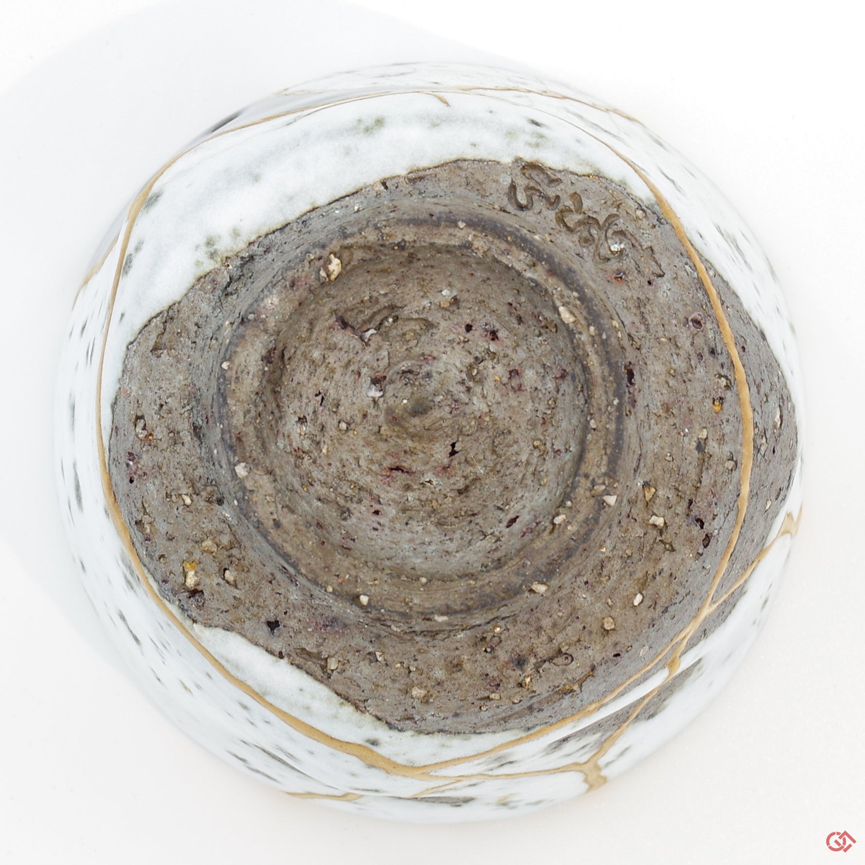 Photo of the bottom side of an authentic Kintsugi pottery piece, showing its overall design and features