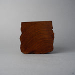 Base view of KODAMA Black Roiro, showing the concentric tree-ring end grain of the aged wood.