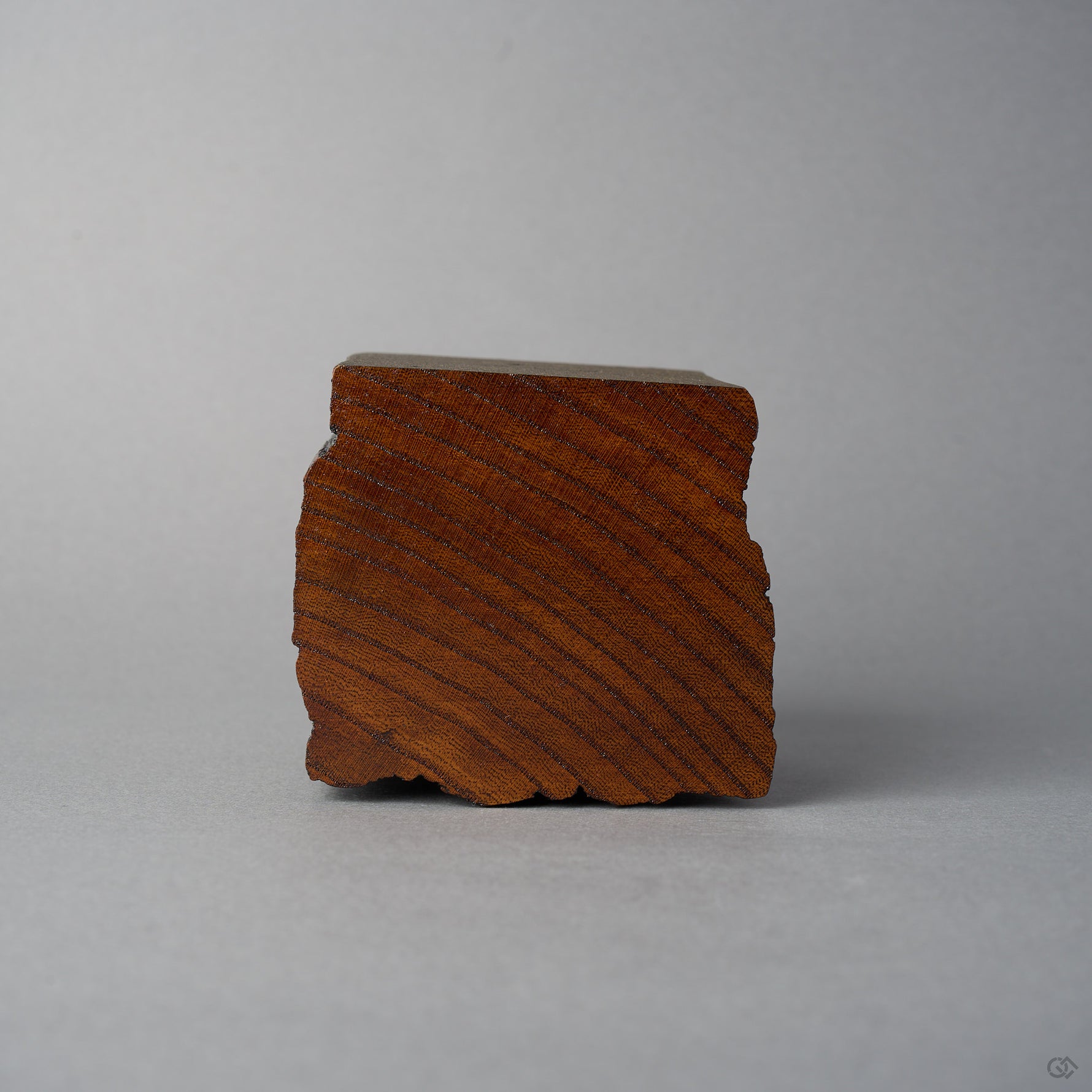 Base view of KODAMA Nashiji, showing the diagonal end-grain pattern of the aged wood.
