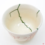 Close-up photo of an authentic Kintsugi pottery, showing the detail of its repairs and craftsmanship