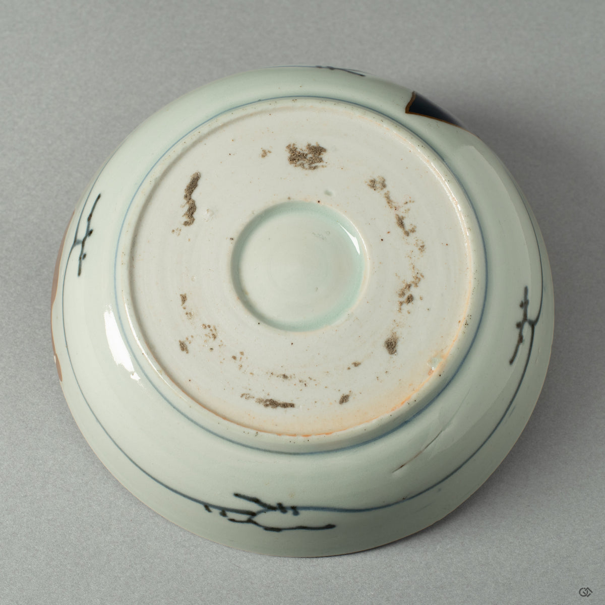 The underside of the Ko-Imari bowl, showing the potter's mark and the quiet integrity of its form, a foundation for its artistic rebirth.