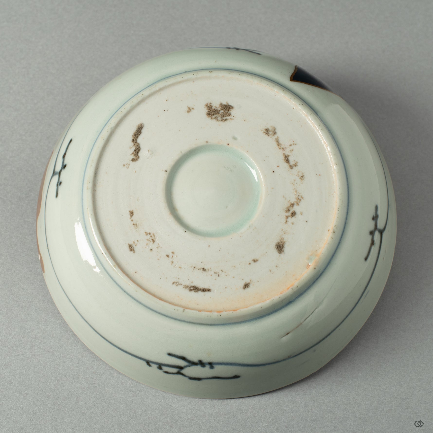 The underside of the Ko-Imari bowl, showing the potter's mark and the quiet integrity of its form, a foundation for its artistic rebirth.
