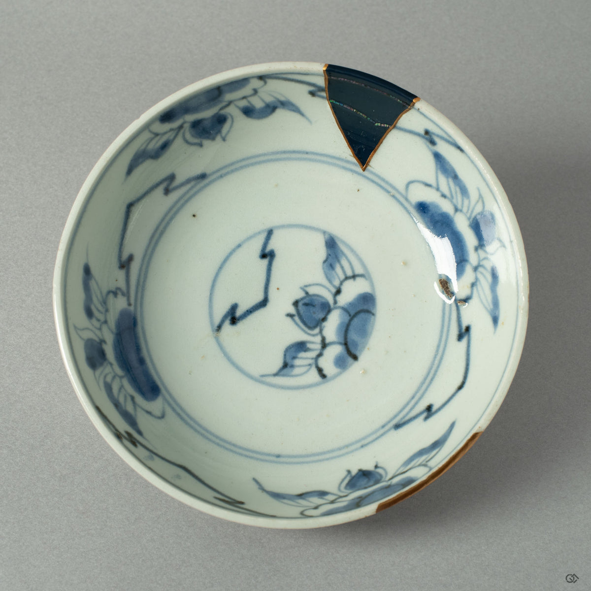 A top-down view of the Ko-Imari bowl, revealing the constellations of gold and Raden inlay scattered across its interior landscape.