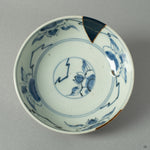 A top-down view of the Ko-Imari bowl, revealing the constellations of gold and Raden inlay scattered across its interior landscape.