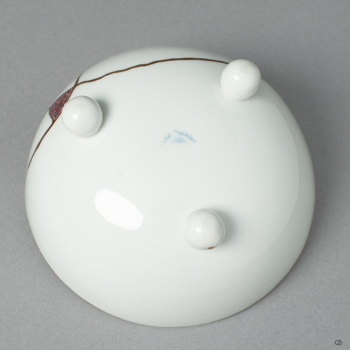 The maker's mark on the base of the restored Noritake cup, a signature of heritage and authentic Japanese craftsmanship' honored by the artist's work.