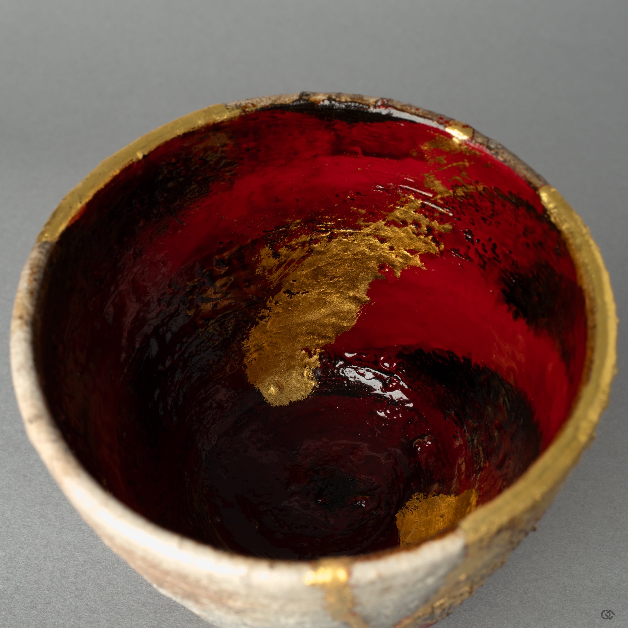 The layered mend of lacquer and gold on the rustic pottery, a quiet moment where the vessels past becomes history made visible through art.