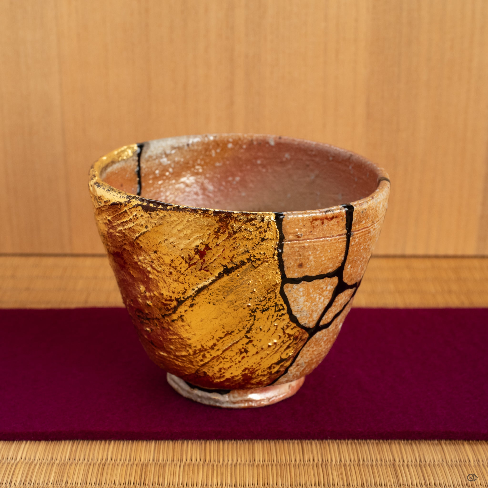 A Shigaraki kintsugi cup on the Japanese tatami and purpule felt, its warmth and texture making it a truly soulful object for a quiet moment of tea.