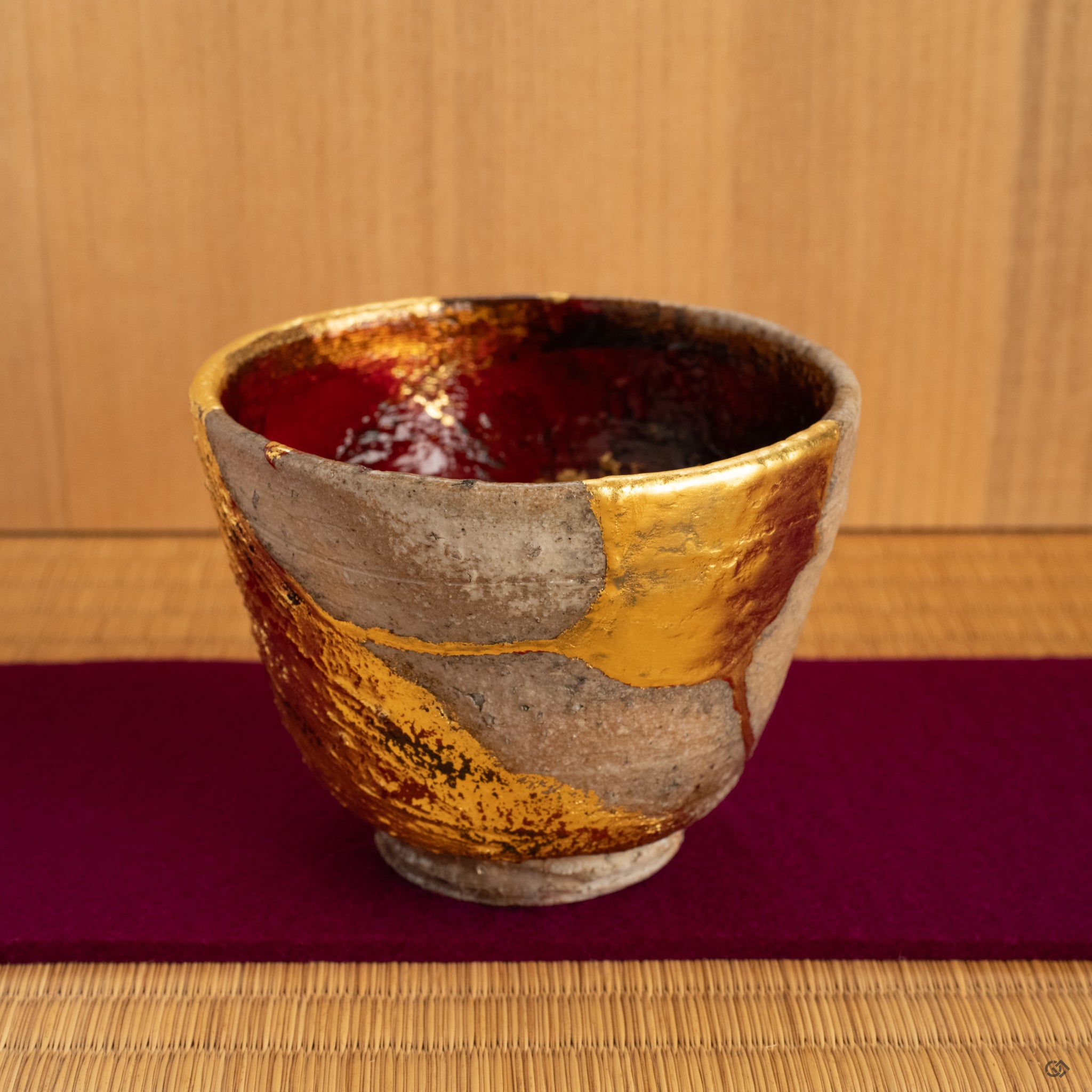 A rustic Shigaraki kintsugi cup held gently, its warmth and renewed form making it a truly soulful object for a quiet moment of tea.
