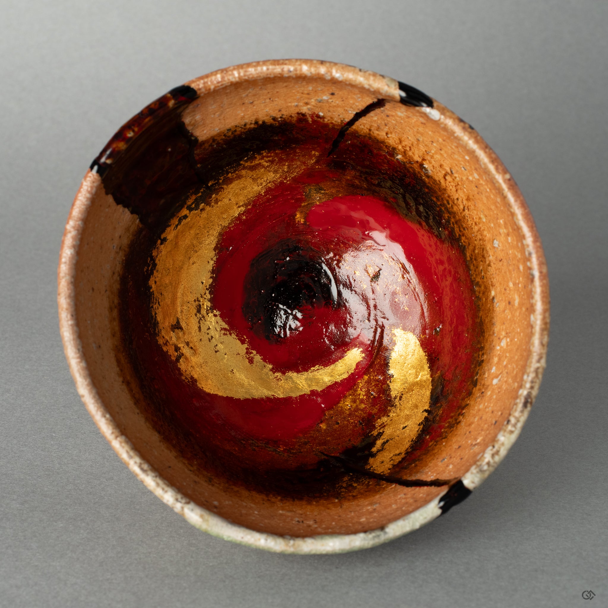 Top-down view into the kintsugi cup, its complex kawarinuri patterns inviting a quiet moment of art as meditation.