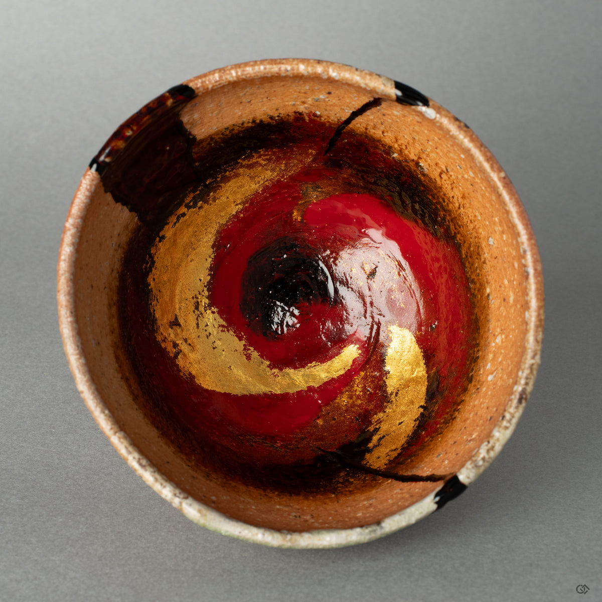Top-down view into the kintsugi cup, its complex kawarinuri patterns inviting a quiet moment of art as meditation.