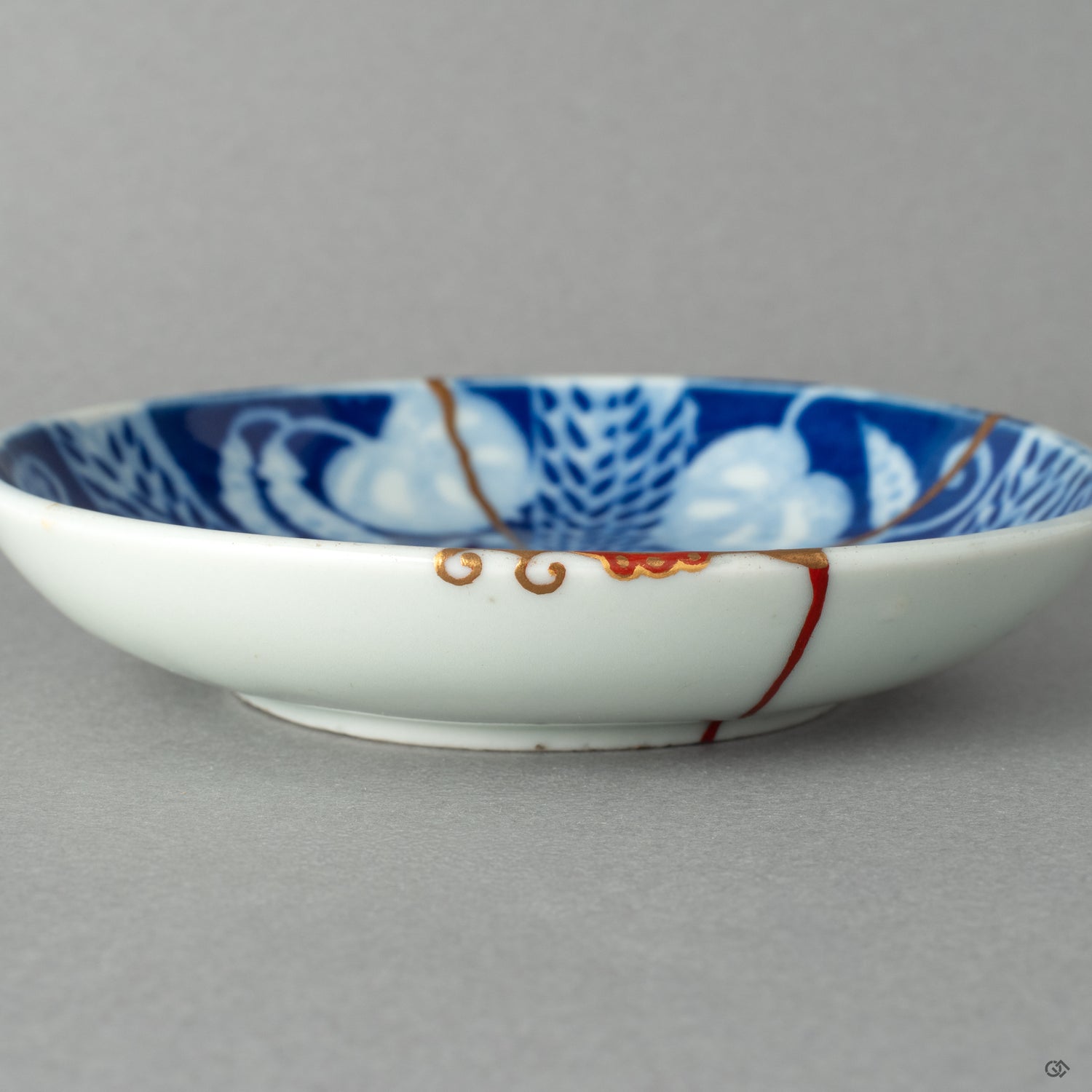 A close-up of the delicate kintsugi repair and Maki-e peas, showcasing a playful new story to tell and the grace in flaws.