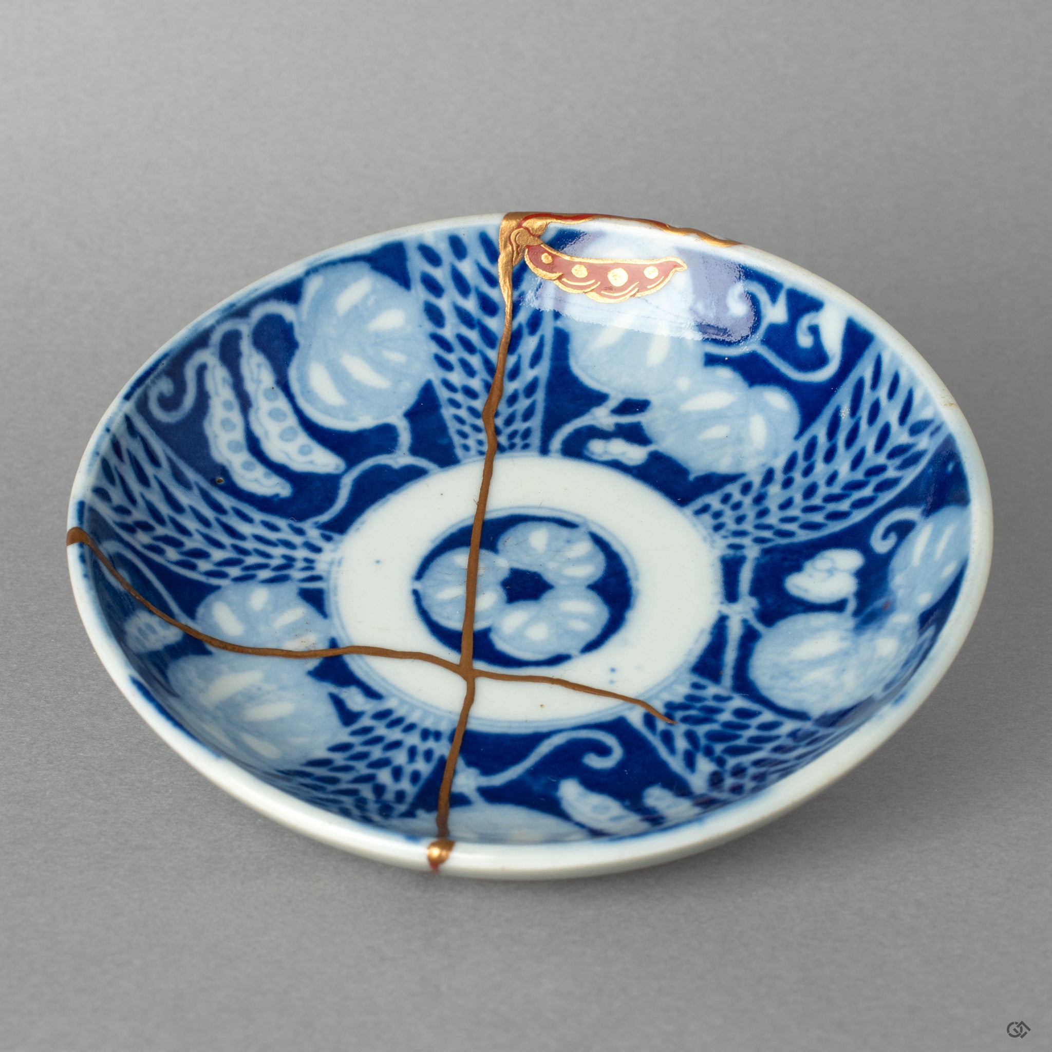 Full view of an authentic kintsugi Ko-Imari small dish, featuring 24K gold and Maki-e, a beautiful tribute to the art of revival.