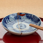 An authentic kintsugi small dish used for presentation, embodying intentional living and the wabi-sabi philosophy of beauty in imperfection.