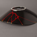 A macro view of the crimson lacquer seam on the bowl's underside, where the artisan's hand reveals the quiet beauty of iro-urushitsugi—a hidden dialogue between break and renewal.