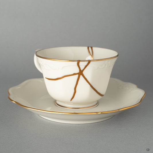 An authentic Japanese Kintsugi Cup & Saucer repaired with 24K Gold artistry, showcasing its serene form and the beauty of imperfection.