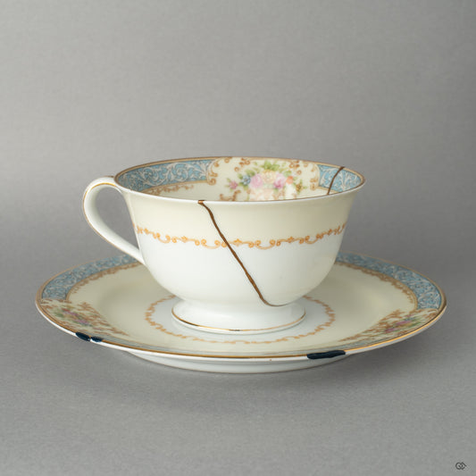Front view of an Early Noritake kintsugi cup and saucer, renewed with 24K gold, giving this vintage set a new story to tell.