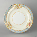 An Early Noritake kintsugi saucer on a linen tablecloth, its golden repair shining, a perfect vessel for intentional living.