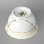 Side profile of the Noritake cup, its delicate kintsugi line a profound vision of resilience made beautiful.