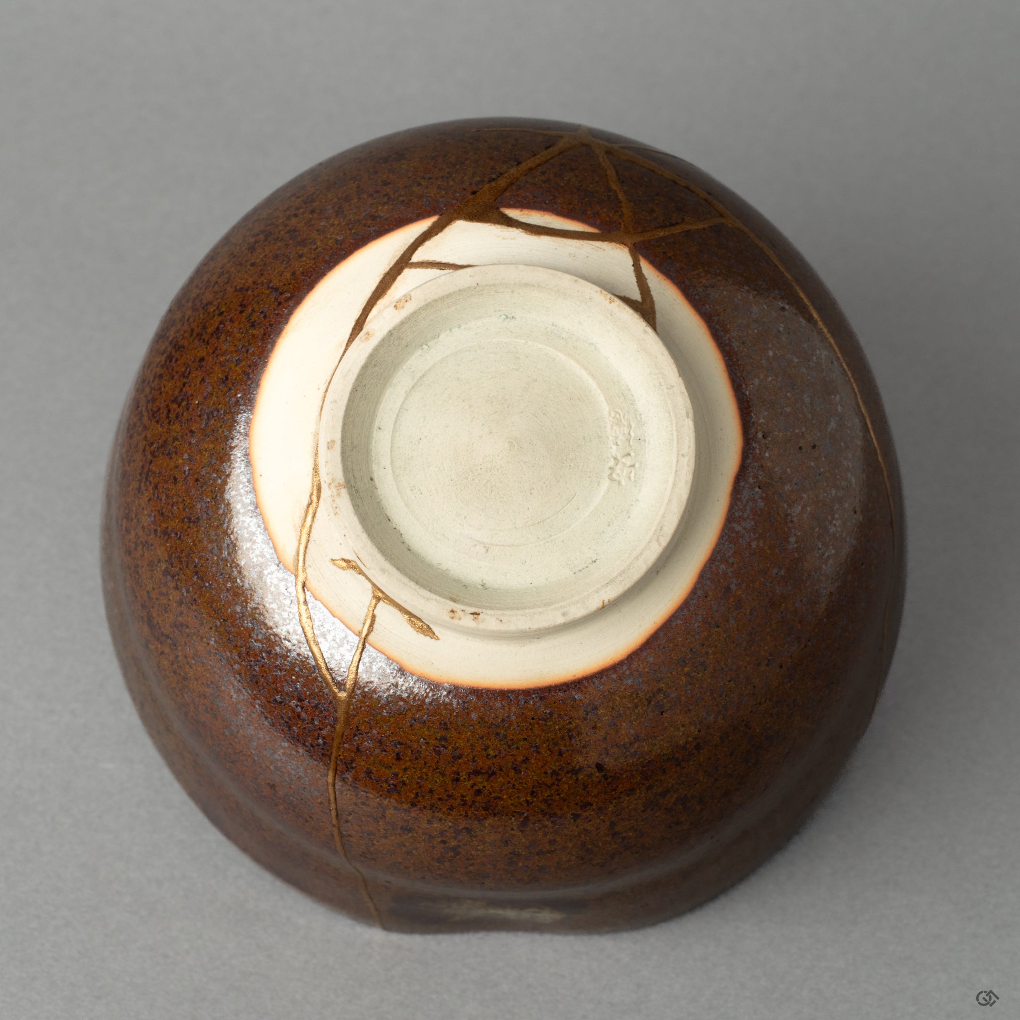 The base of a Kyoto ware matcha bowl, where the kintsugi repair meets the potters mark, honoring true Japanese craftsmanship.