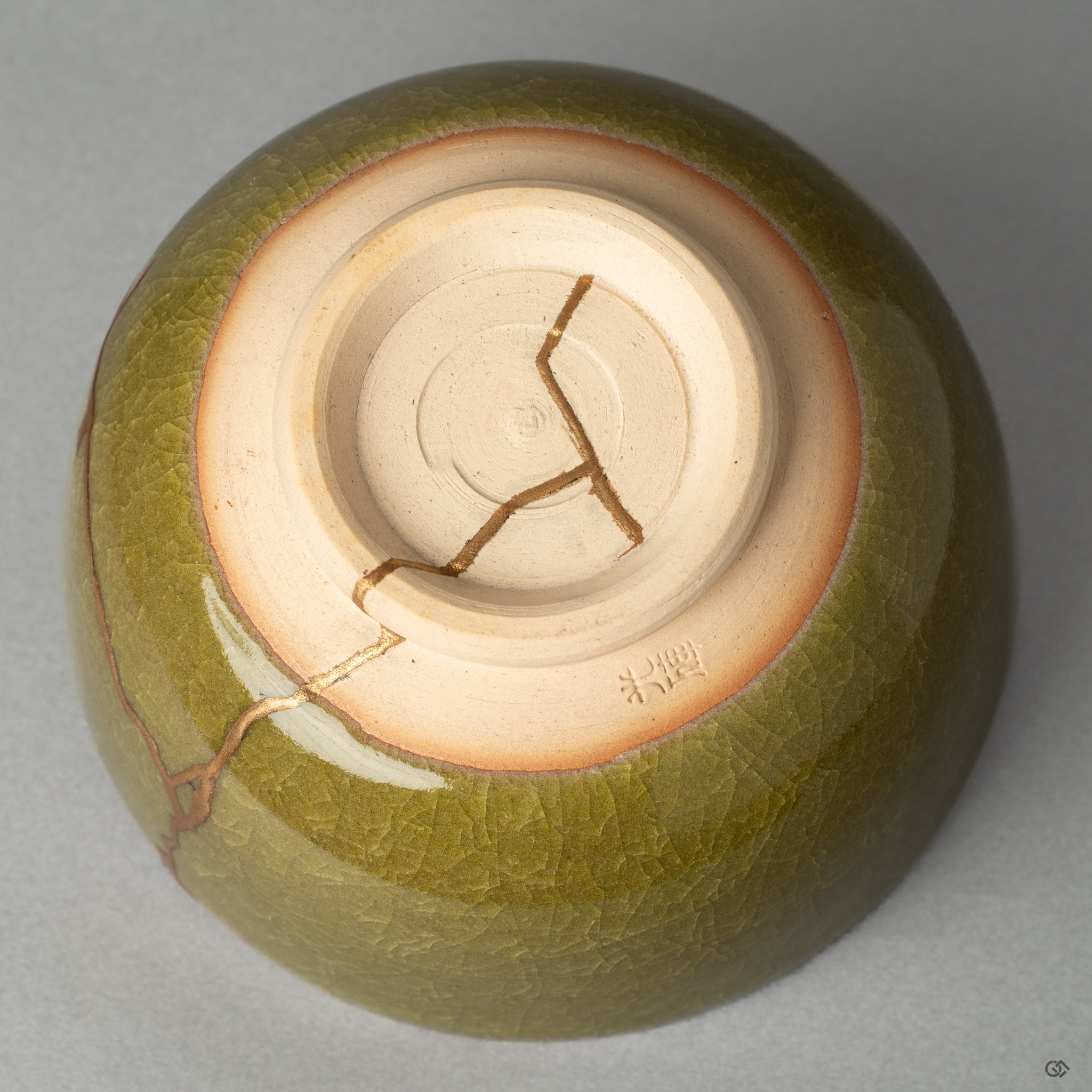 The base of a Kyoto ware matcha bowl, where the kintsugi repair meets the potters mark, honoring true Japanese craftsmanship.