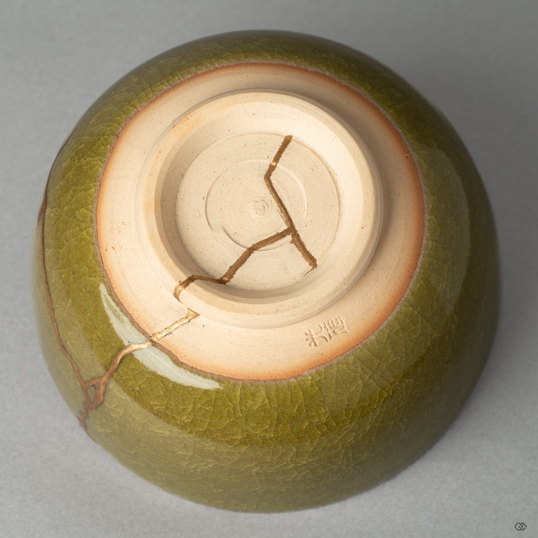 The base of a Kyoto ware matcha bowl, where the kintsugi repair meets the potters mark, honoring true Japanese craftsmanship.