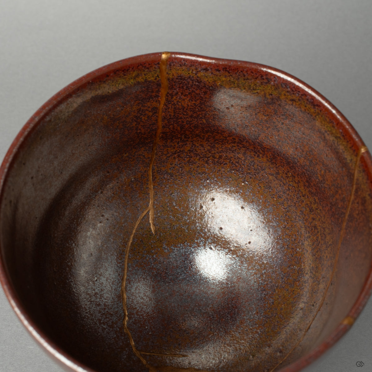 A macro view of the kintsugi seam inside the matcha bowl, telling a silent story in every seam of its thoughtful restoration.