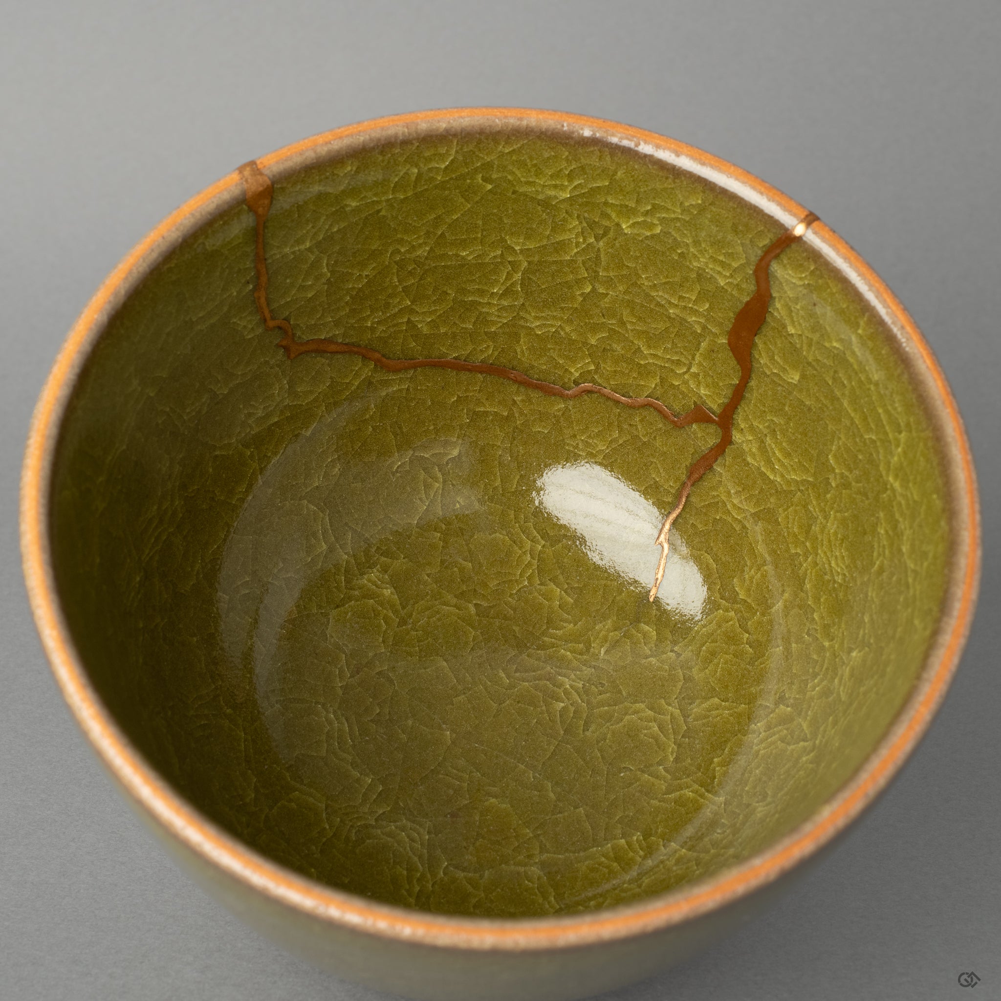 A close-up of the bowls interior, where the precise golden joinery of the kintsugi repair shines, a story of healing told in pure gold.