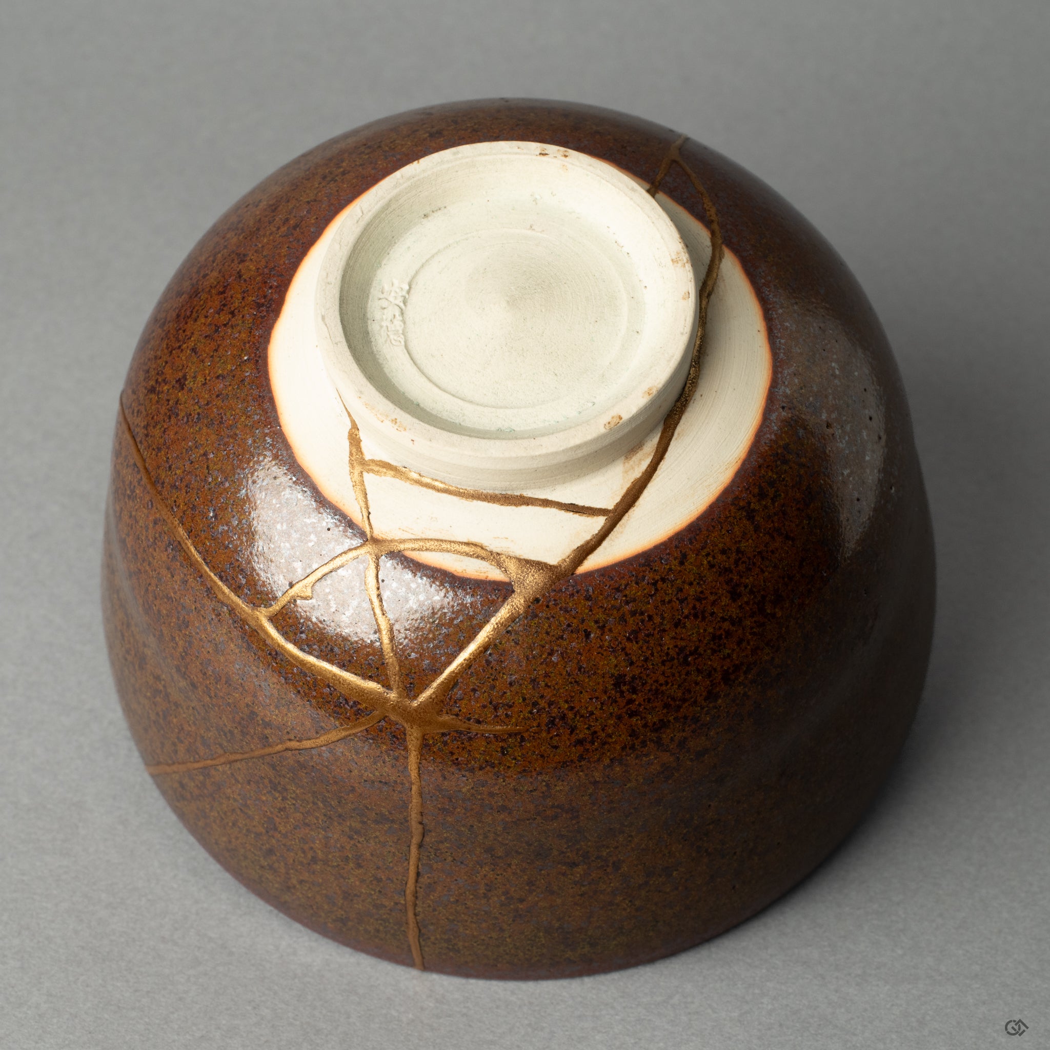 An upward view of the kintsugi matcha bowls base, showcasing the considered restoration that makes this a soulful object.