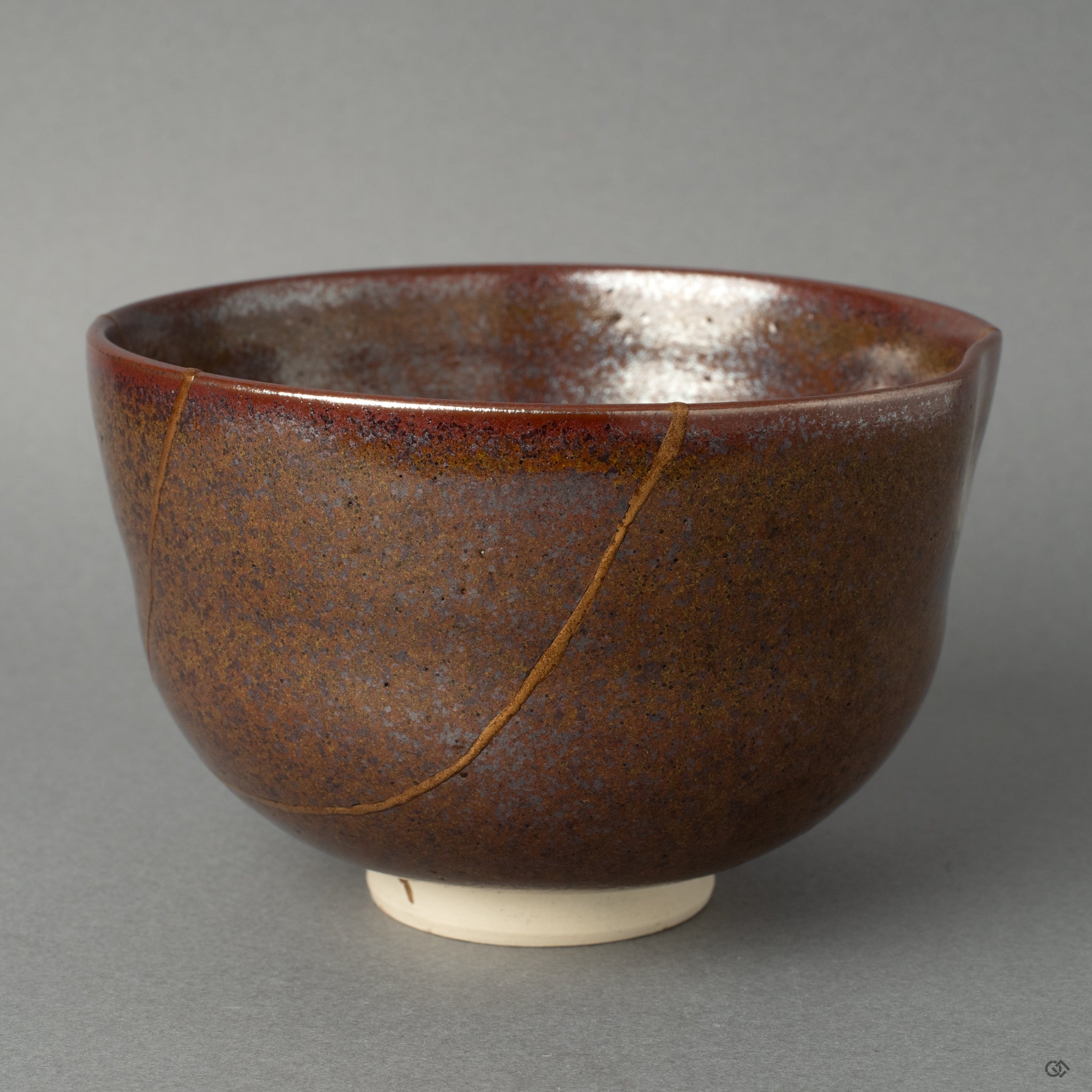 Side view of a kintsugi matcha bowl, the 24K gold seam tracing its form, a profound vision of resilience made beautiful.