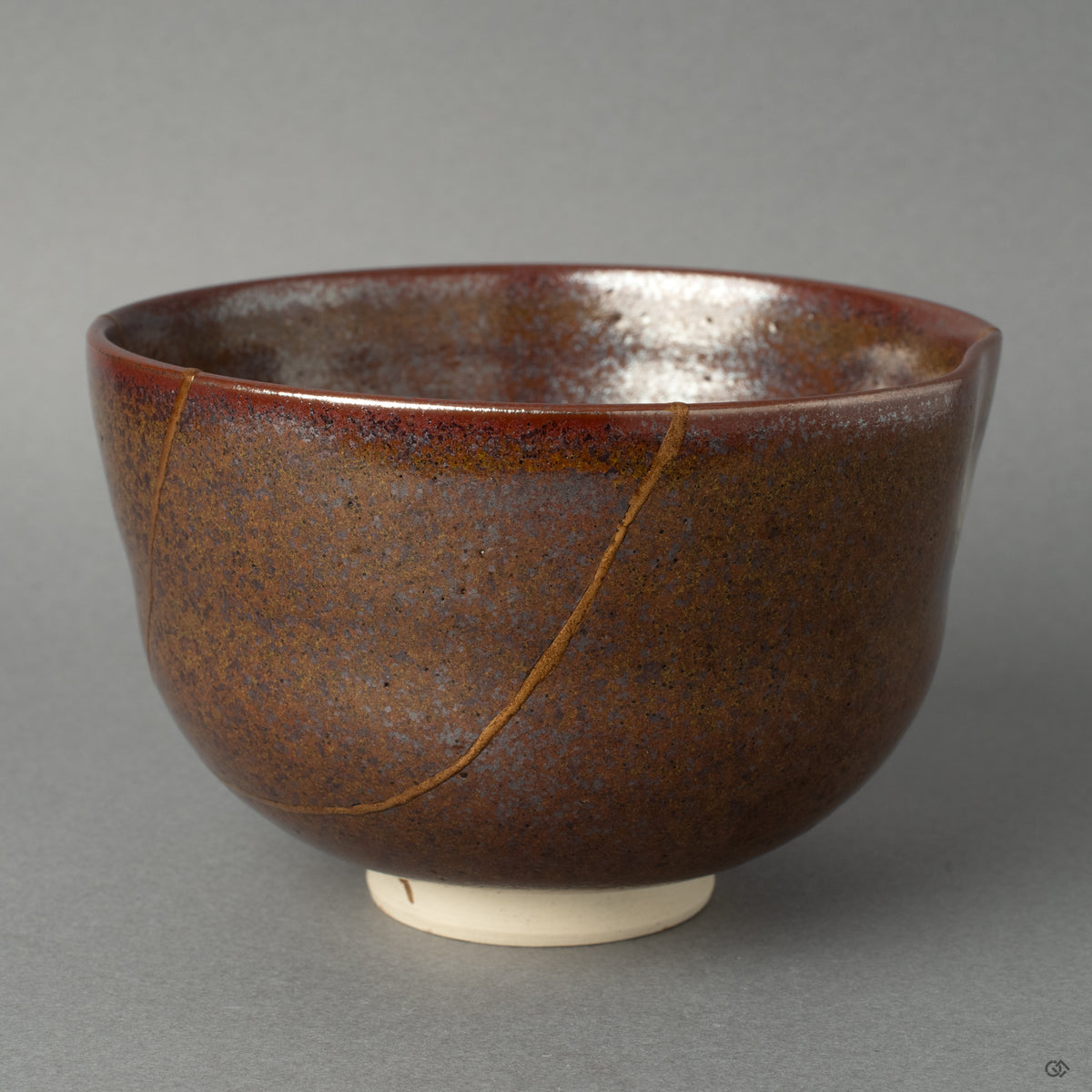 Side view of a kintsugi matcha bowl, the 24K gold seam tracing its form, a profound vision of resilience made beautiful.