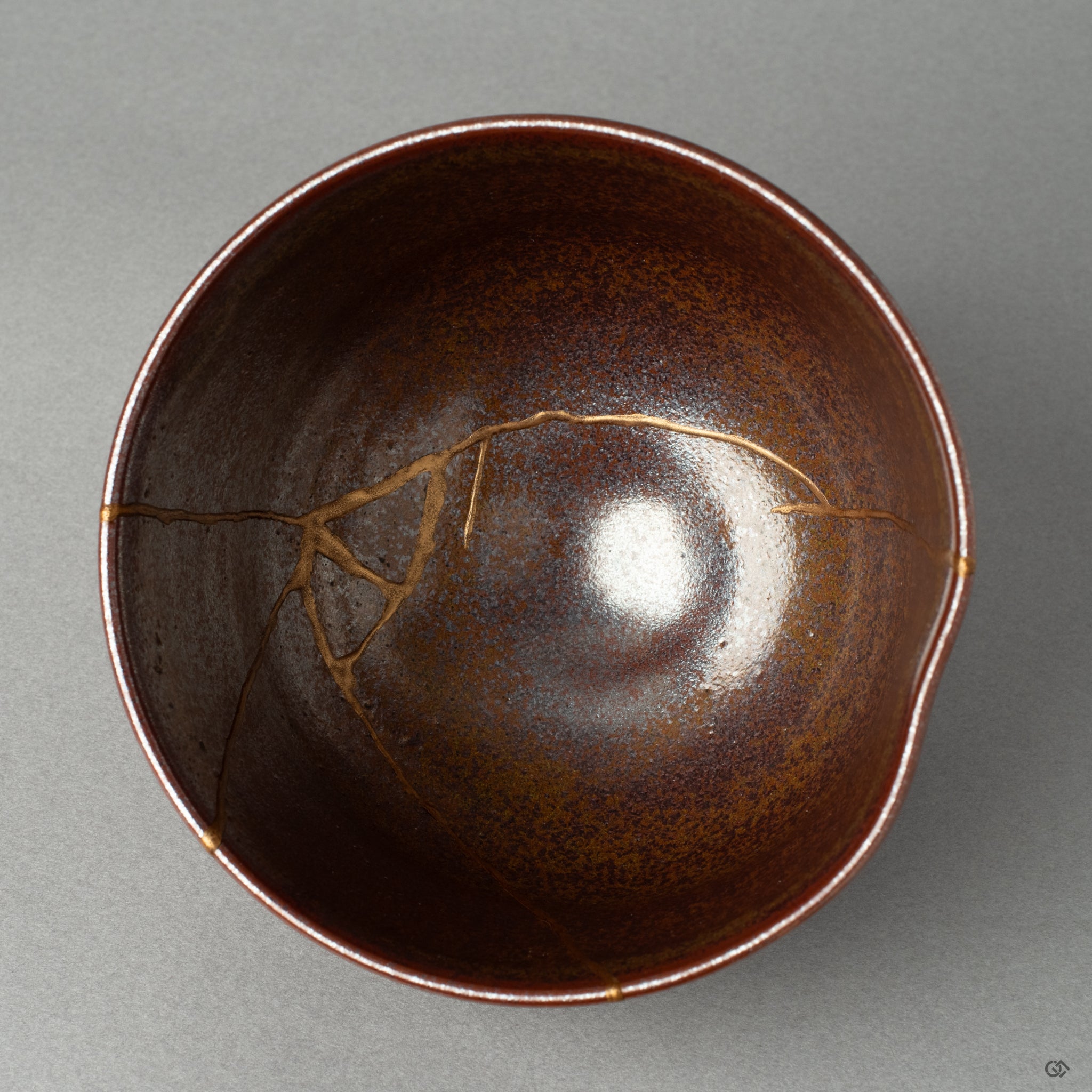 A top-down view into a kintsugi matcha bowl, the golden line a quiet testament to finding beauty in imperfection and the art of wabi-sabi.