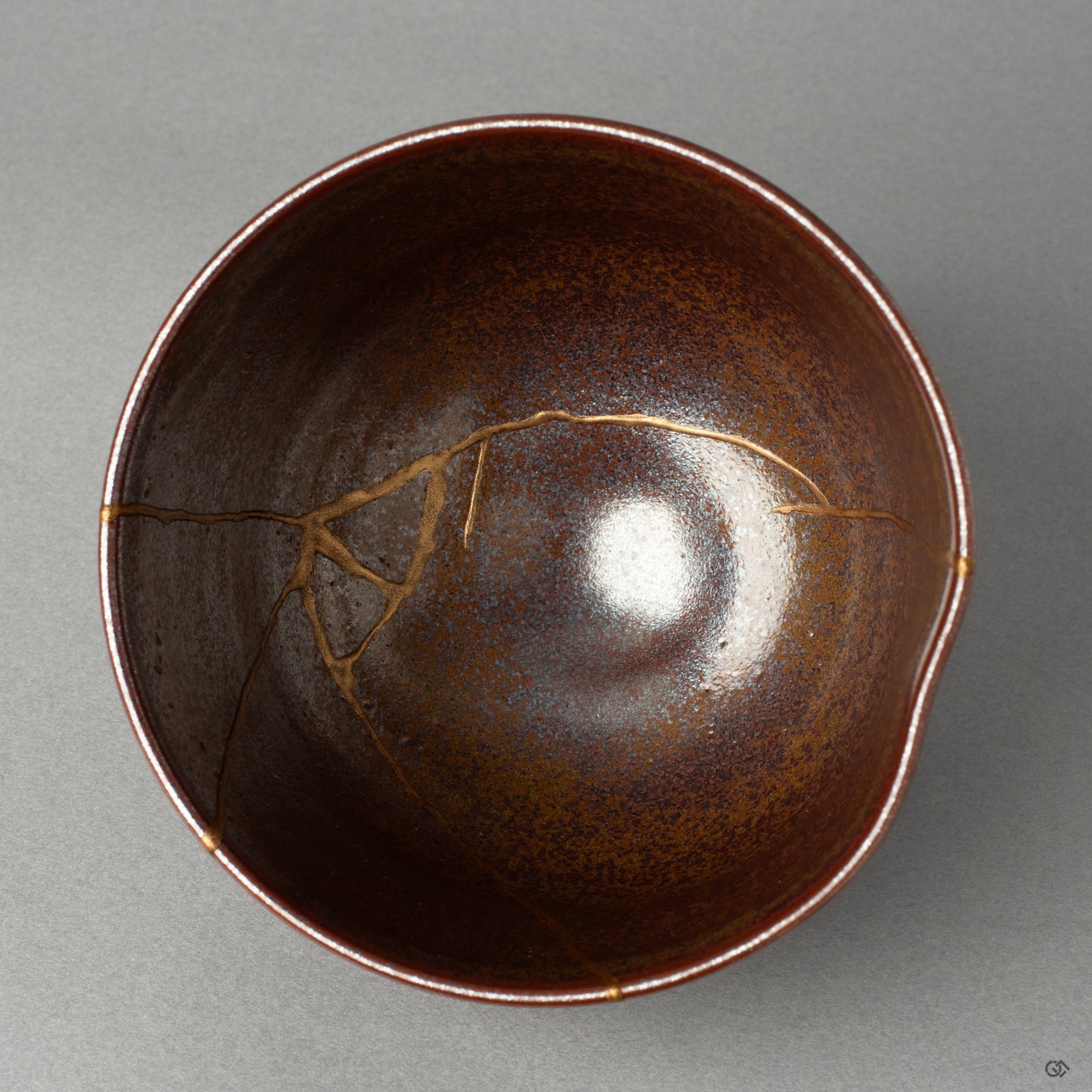A top-down view into a kintsugi matcha bowl, the golden line a quiet testament to finding beauty in imperfection and the art of wabi-sabi.