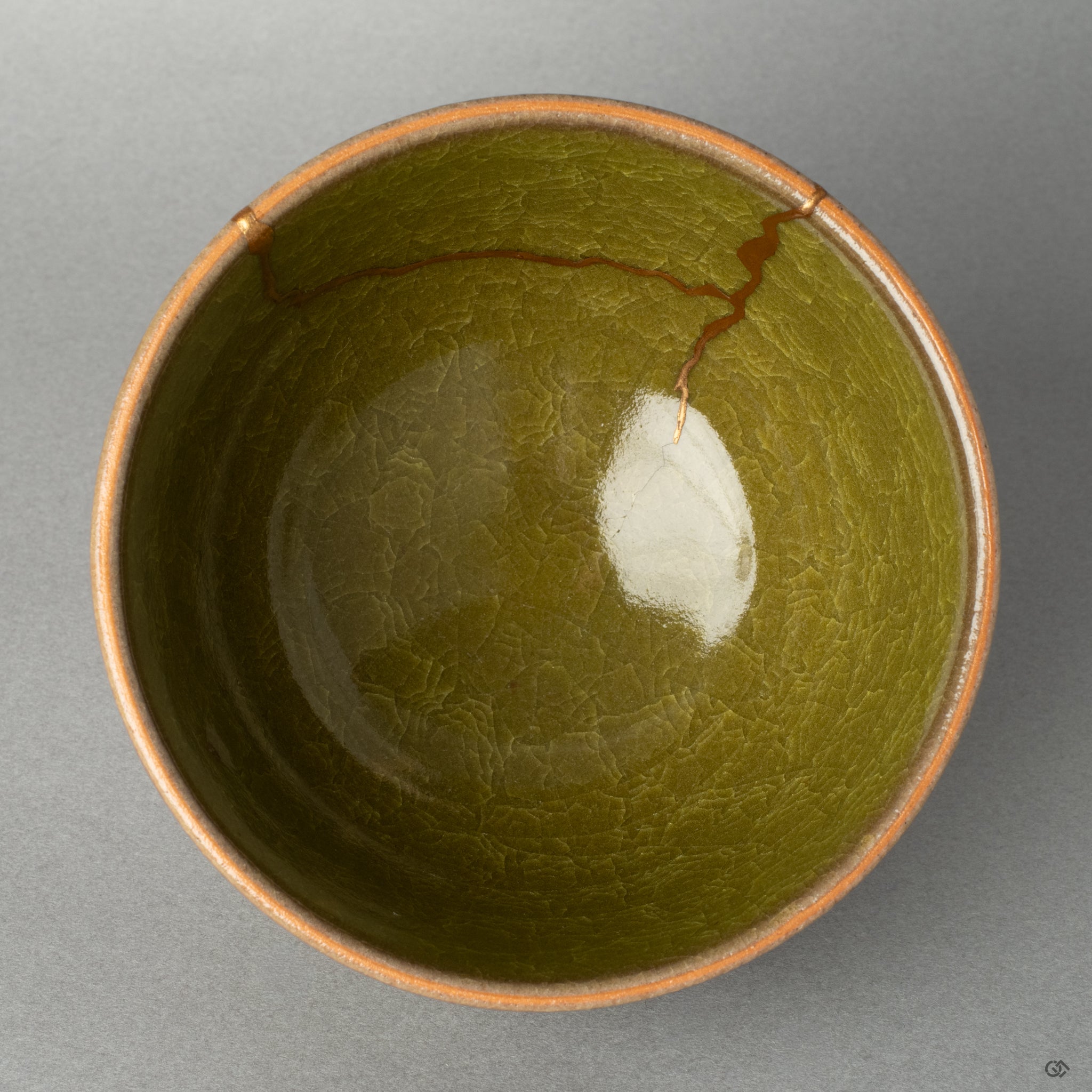 A top-down view into a kintsugi matcha bowl, the golden line a quiet testament to finding beauty in imperfection and the art of wabi-sabi.