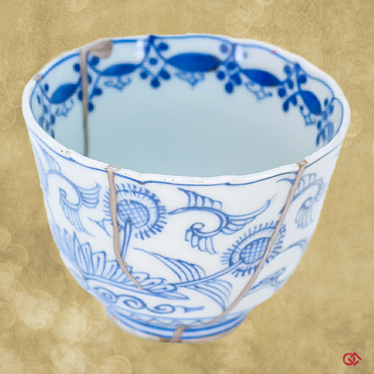 A full-color image of an authentic Kintsugi pottery piece, showing its intricate repairs and unique design.