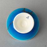 Bottom view of a kintsugi-repaired sake cup, a powerful investment in beauty and a treasured heirloom.
