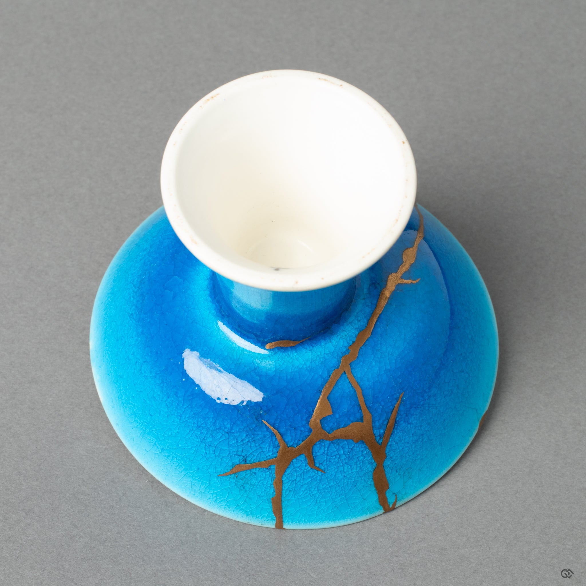 A close-up of the kintsugi lines on a sake cup, revealing a story in every seam—a true philosophy in form.
