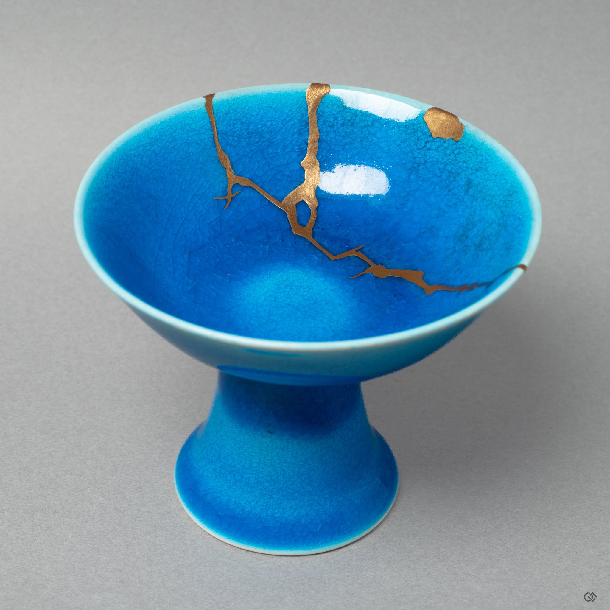 Full front view of a kintsugi Arita sake cup, mended with traditional urushi lacquer and 24K gold, celebrating the art of revival.