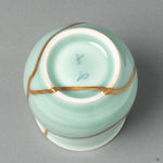 View of the footed base of the Nabeshima ware tea cup, showing the continuation of the 24k gold Kintsugi repair on the piece's underside.
