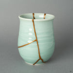 A view of the golden repair's delicate path, a testament to the wabi-sabi philosophy of finding profound beauty in an object's unique story.