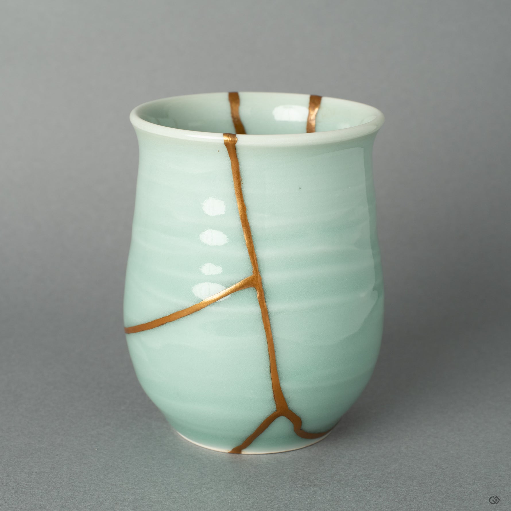 A view of the golden repair's delicate path, a testament to the wabi-sabi philosophy of finding profound beauty in an object's unique story.