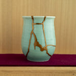 The Kintsugi tea cup presented in a serene lifestyle setting, embodying the "Book of Tea" philosophy of finding art in daily life.